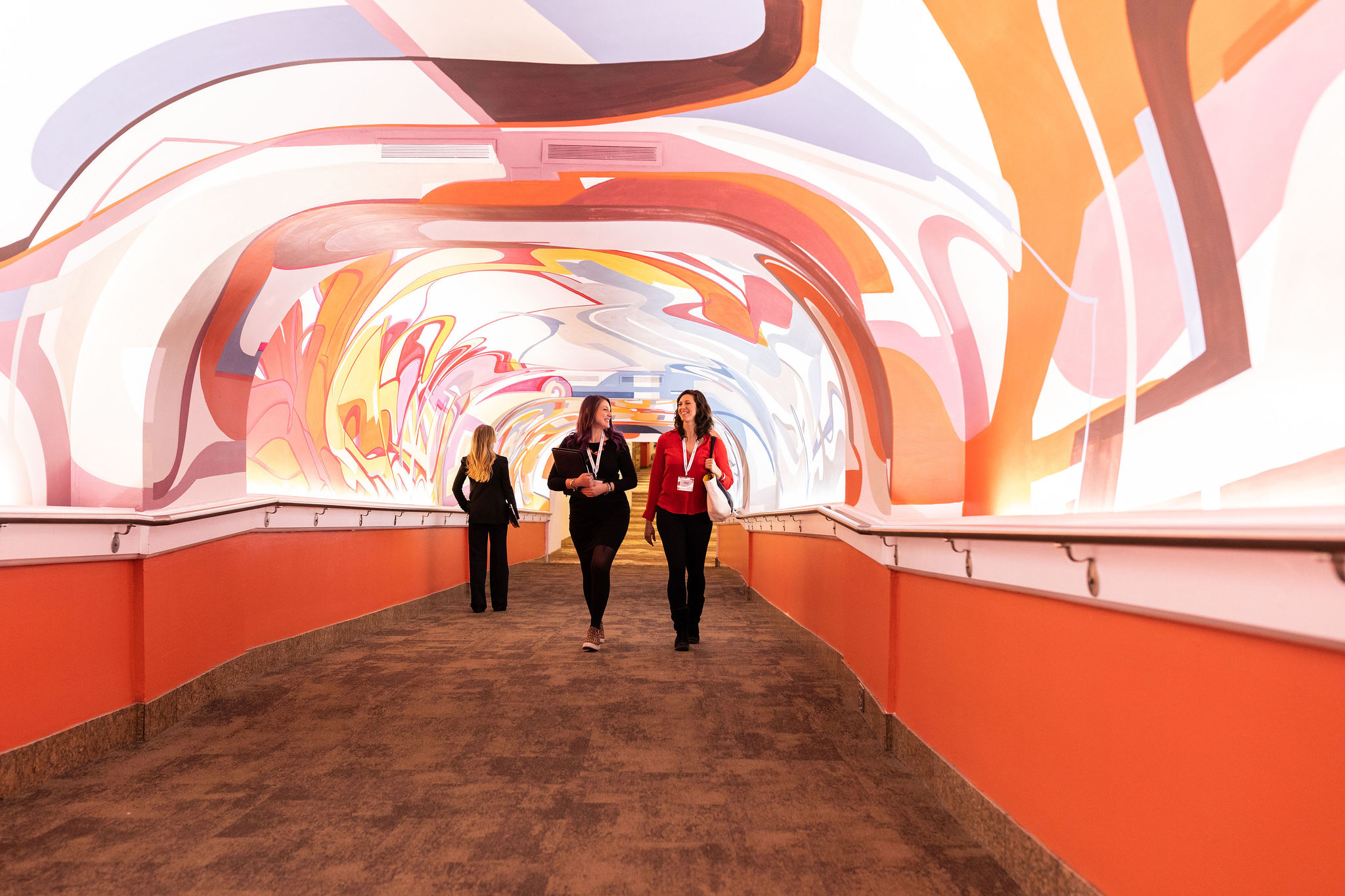 Women walking in colorful Hall