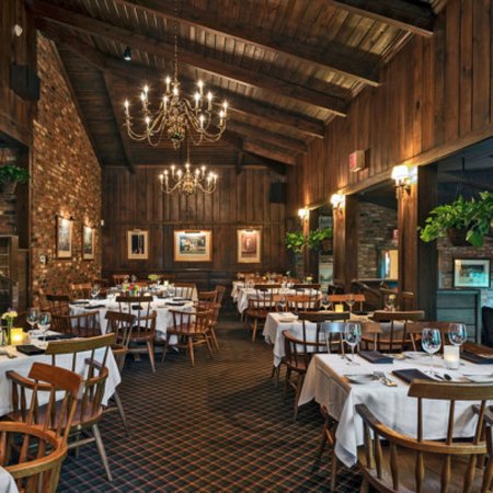 Indoor dining tables in a wood paneled room