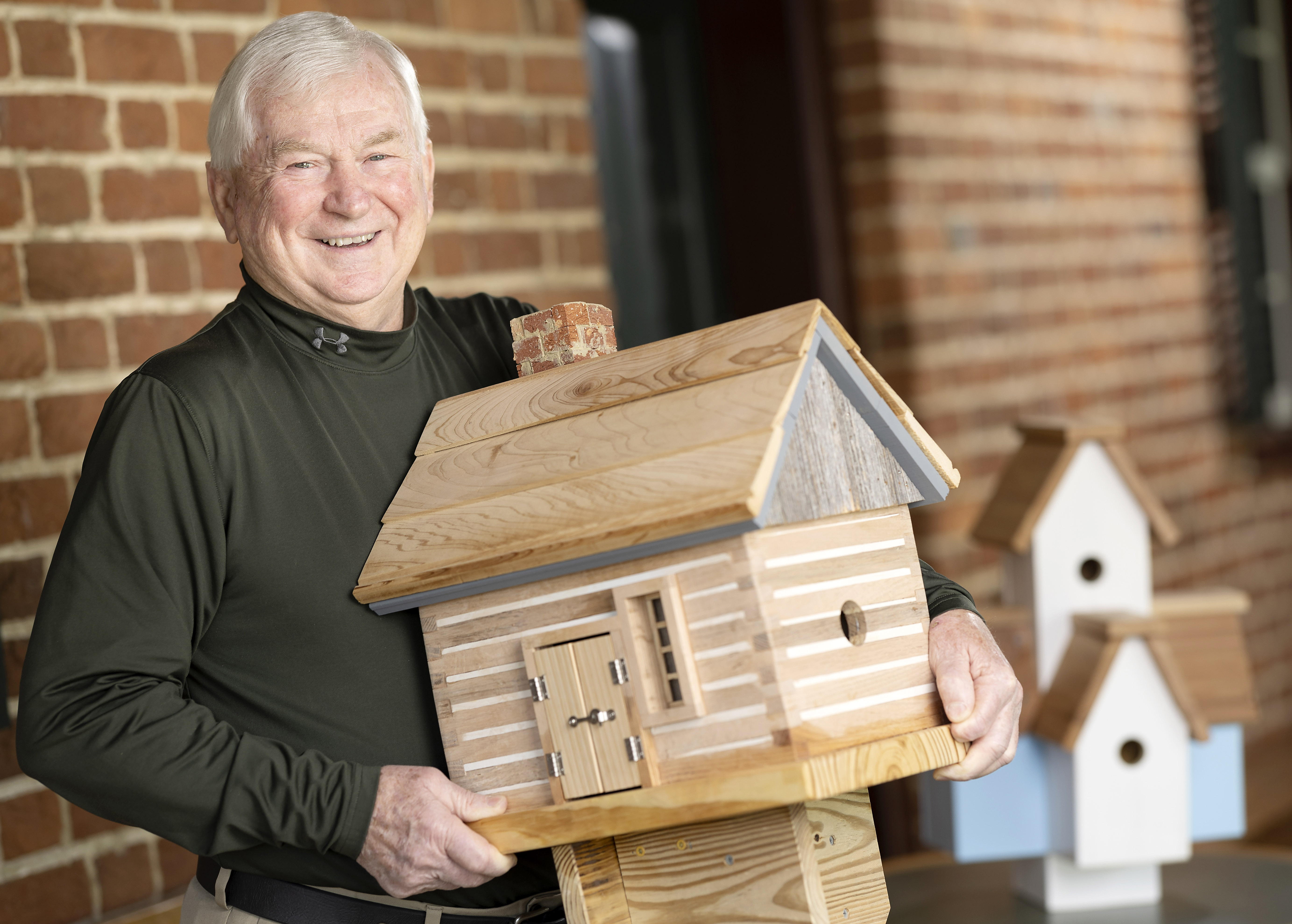 Bobby Davis holding a birdhouse he built