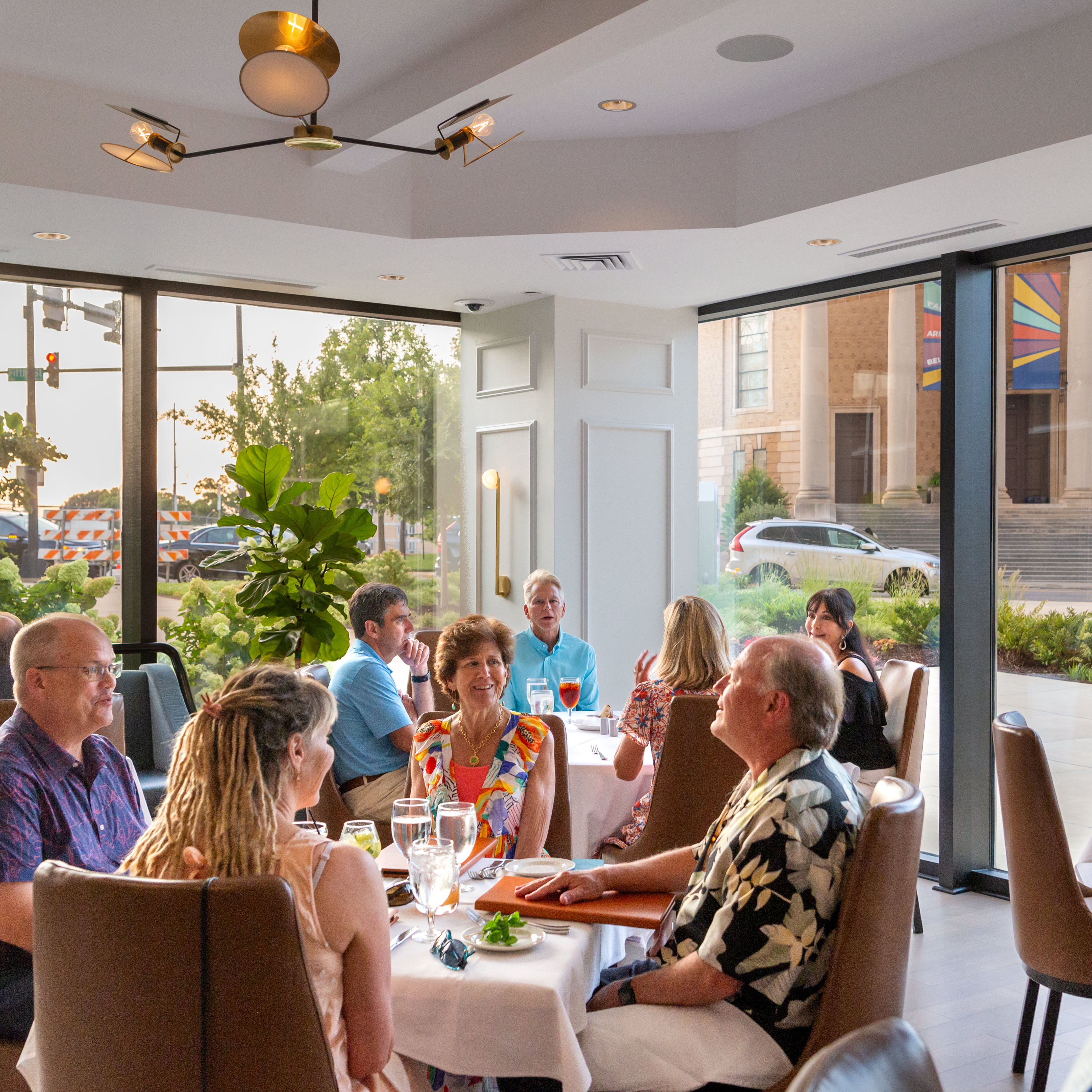 A group of people sitting at a table with a white tablecloth at the Downtown Grille in Winston-Salem