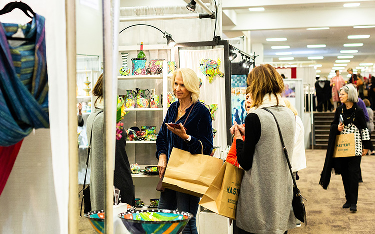 Shoppers explore the booths for unique gifts at the Piedmont Craftsmen's Fair in Winston-Salem