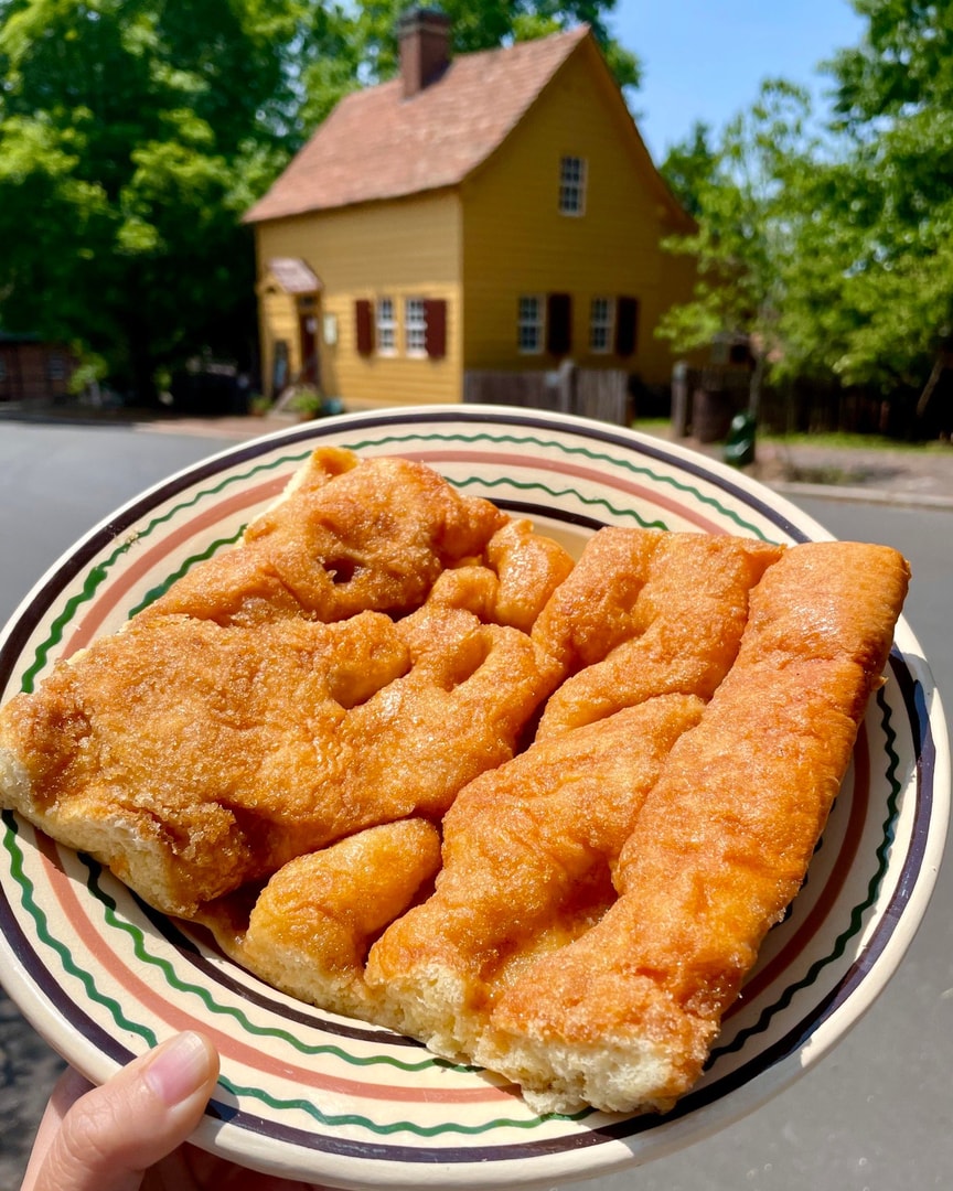 A slice of Moravian sugar cake on a plate in Old Salem, Winston-Salem