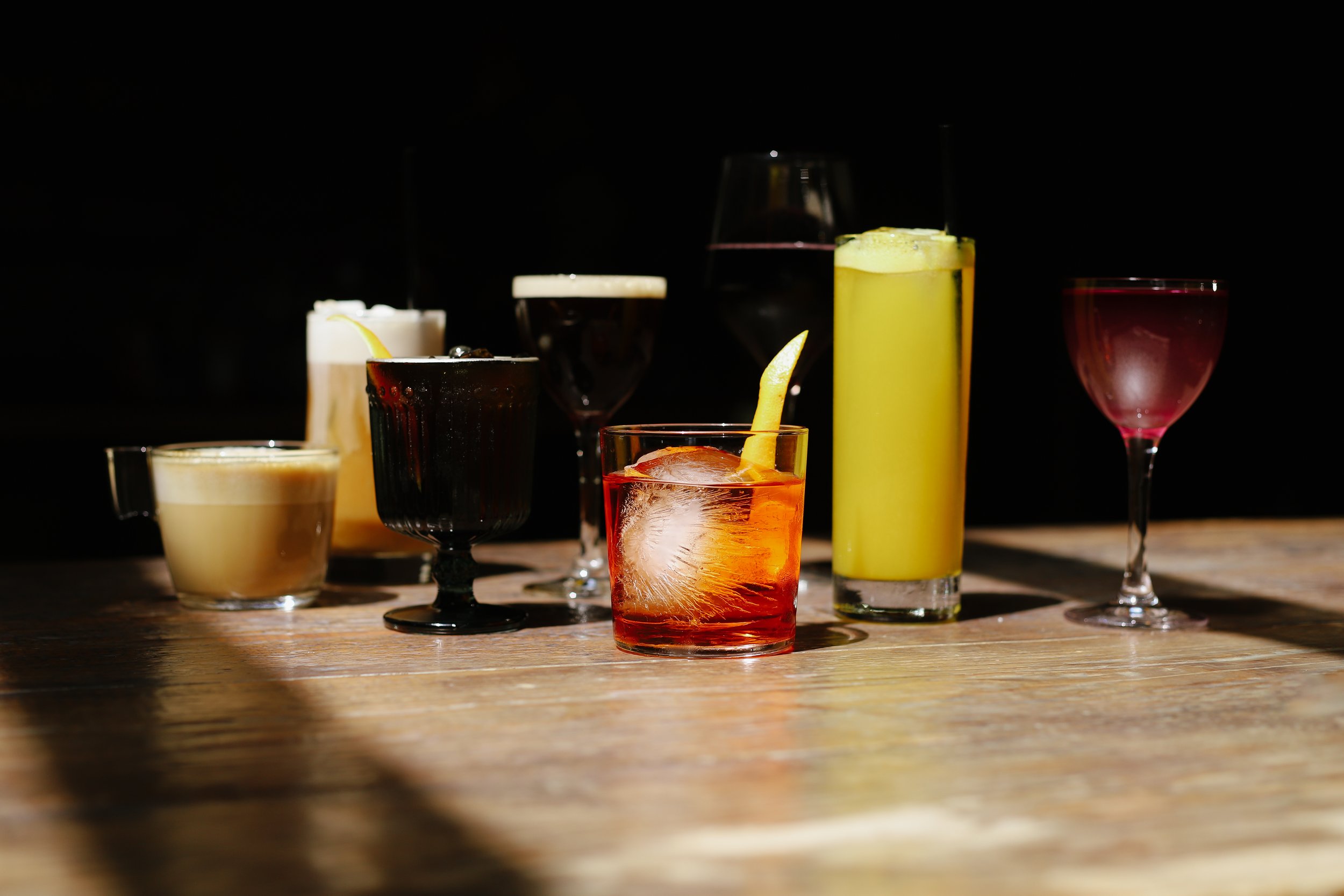 A lineup of cocktails on the bar at easytalk, a bar in Winston-Salem