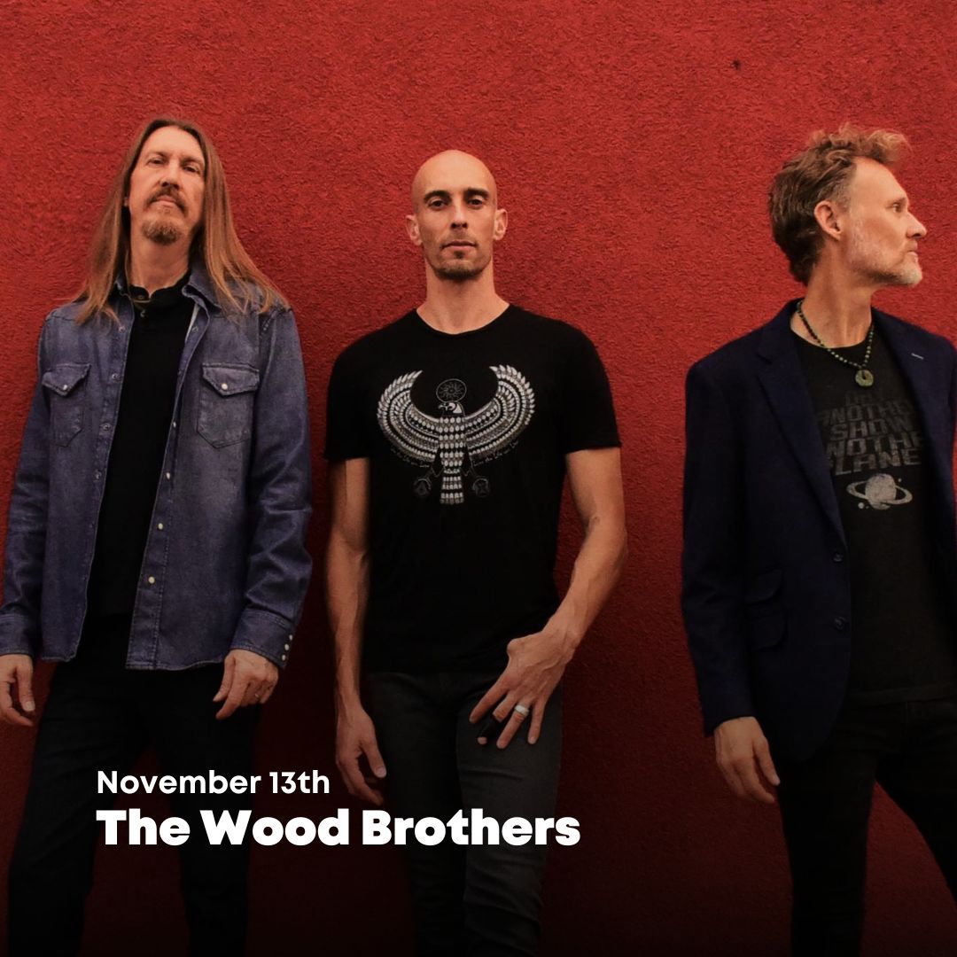 Photo of The Wood Brothers against a red background