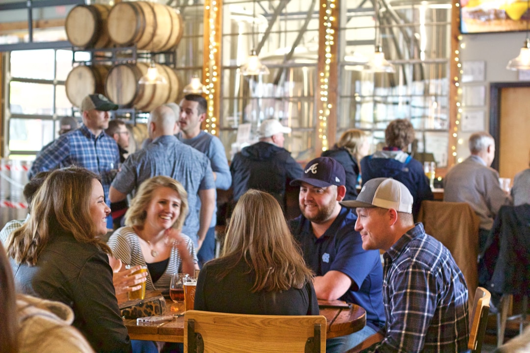 A group of people enjoying drinks at Fiddlin' Fish Brewing in Winston-Salem