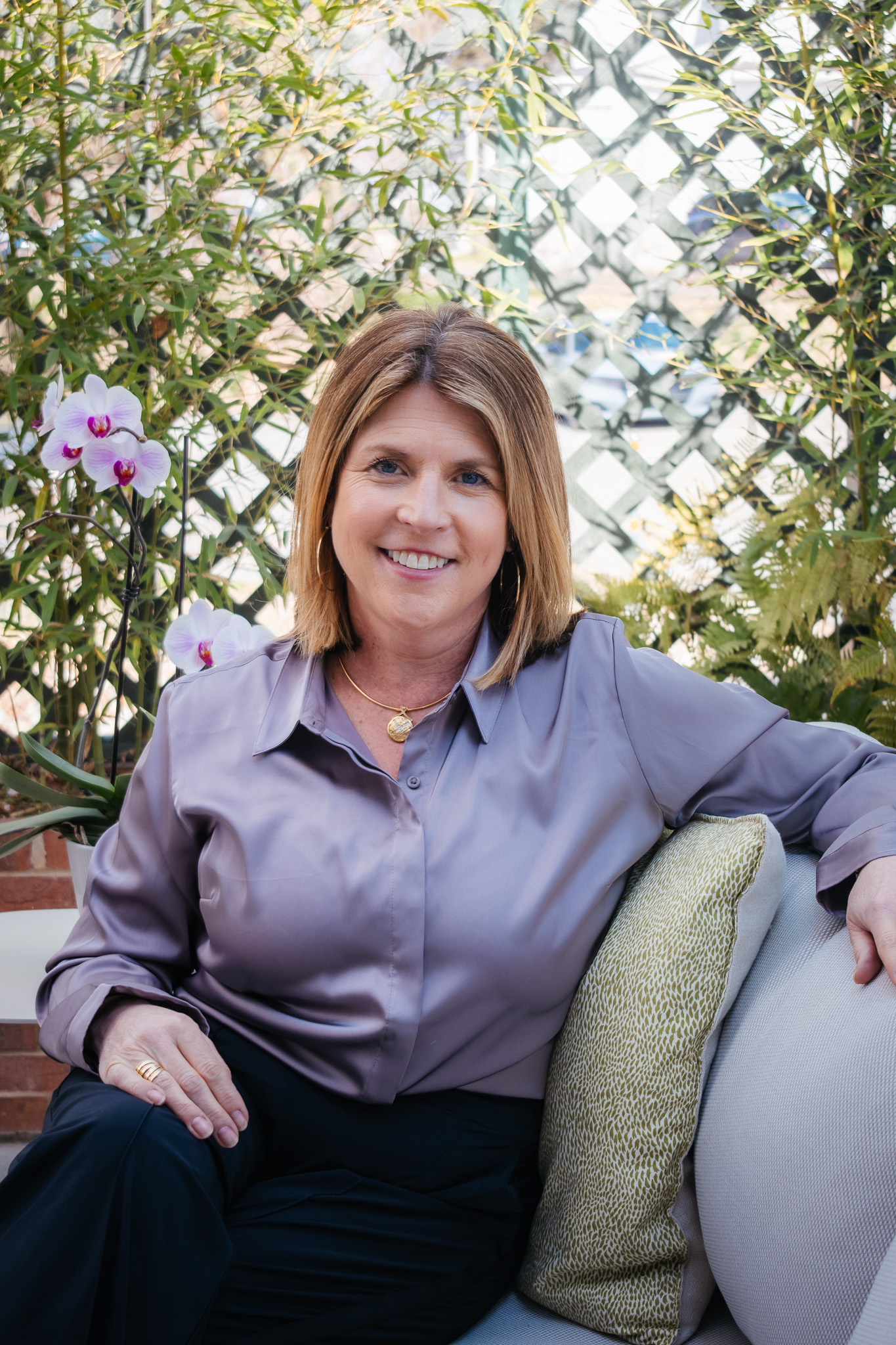 Jennifer Smith- owner of Betty on Burke and Mozelle's Southern Bistro in Winston-Salem- sits on a chair on a covered patio.