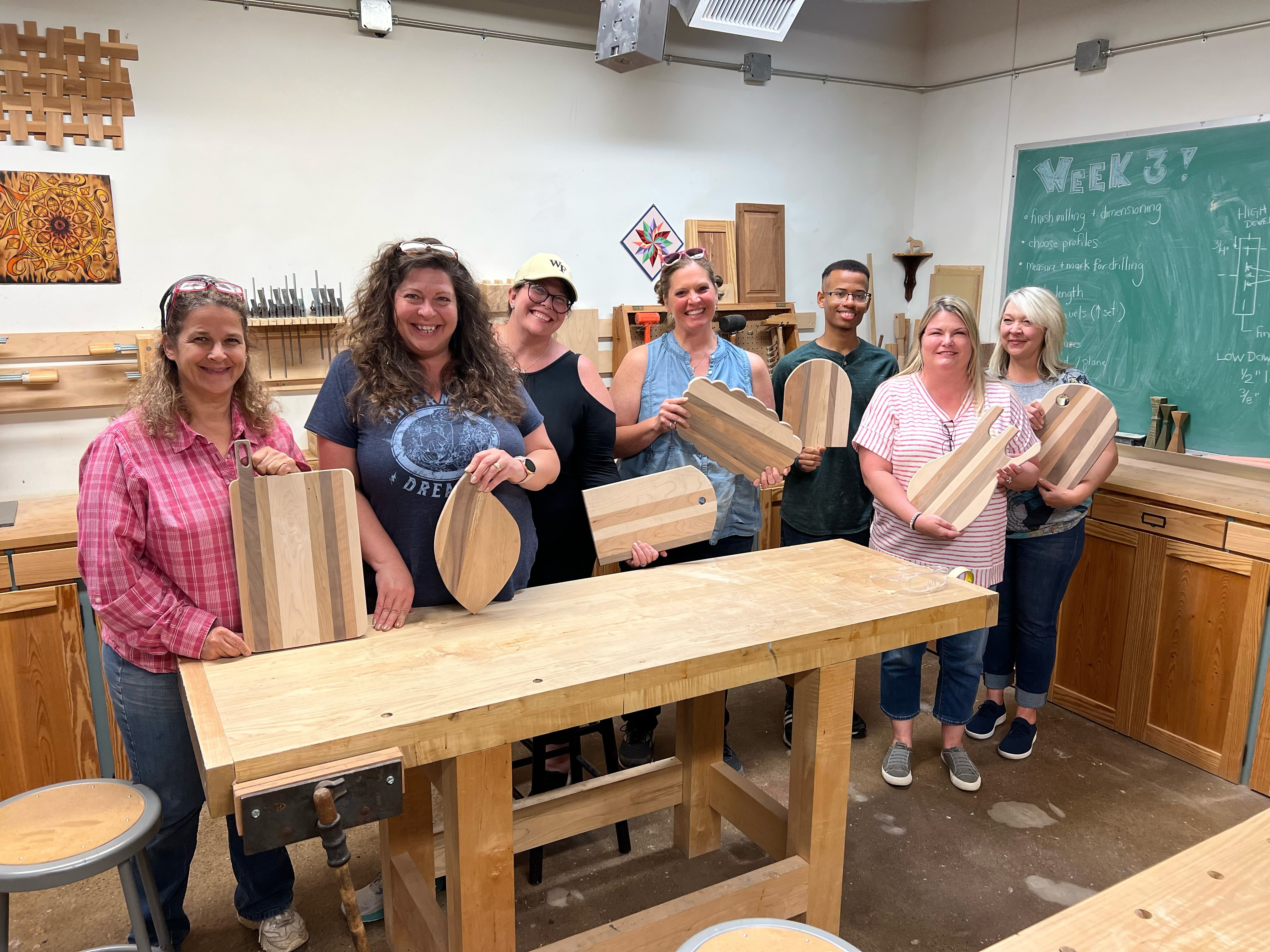 A group of women showcase their work after taking a wood working class at Sawtooth School for Visual Art in Winston-Salem, North Carolina.