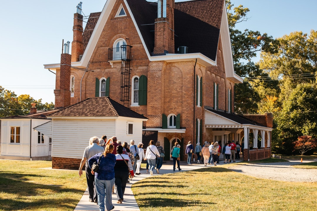 A group tour commences outside of Korners Folly Historic House in Kernersville, North Carolina.