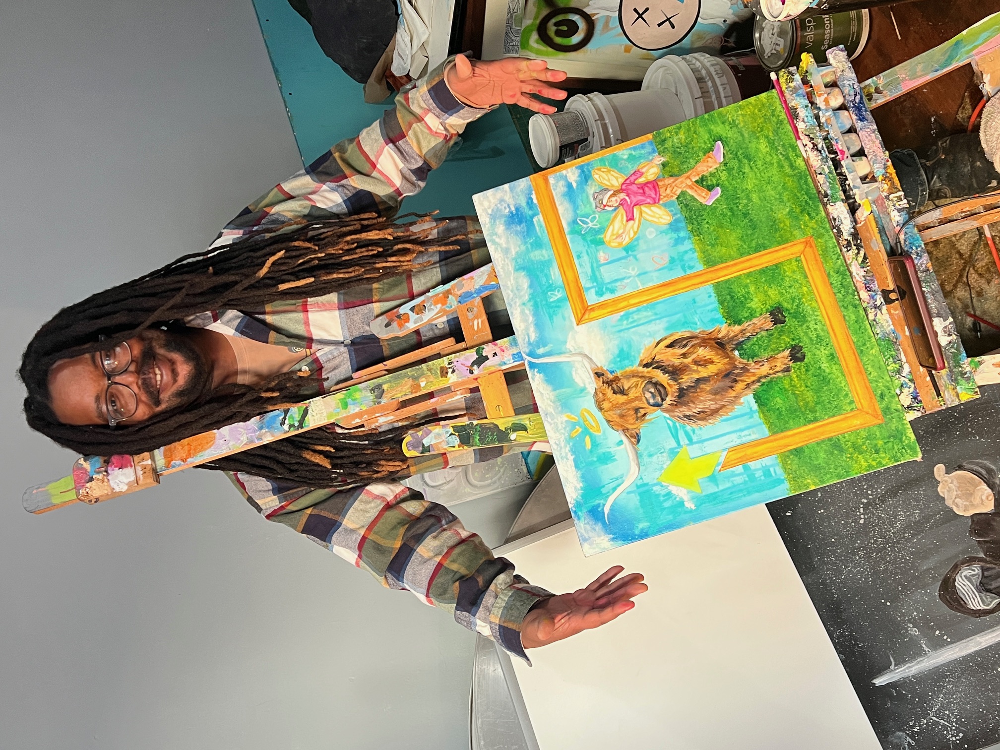 A photo of local artist Art Dezo in front of one of his paintings, located in Winston-Salem.
