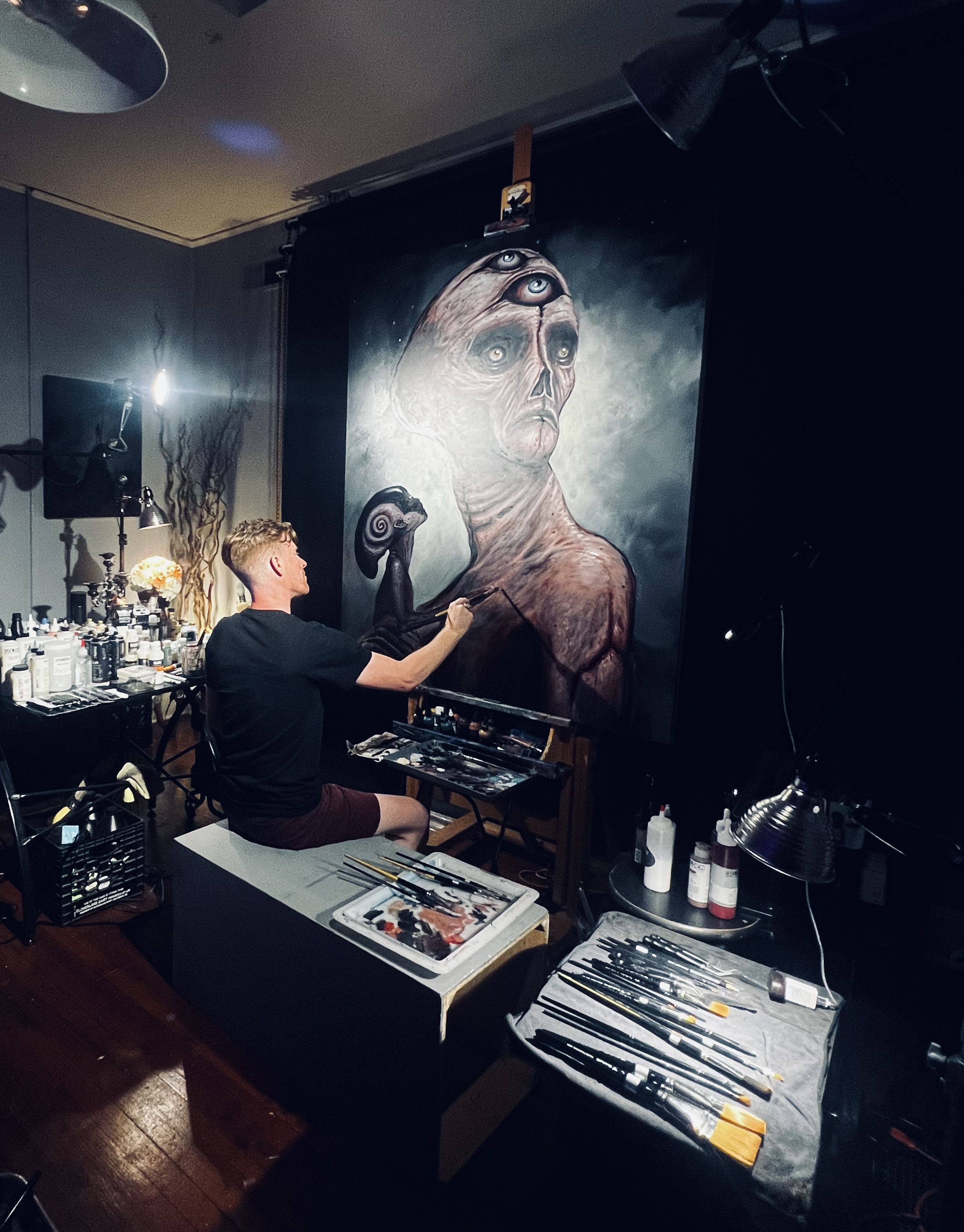 Dane Walters sits in front of his art in his studio in Winston-Salem, North Carolina.