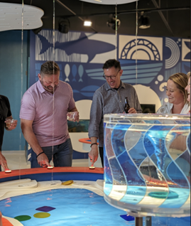 A group of adults tours the "Wonders of Water" exhibit at the Kaleideum Children's Museum in Winston-Salem.
