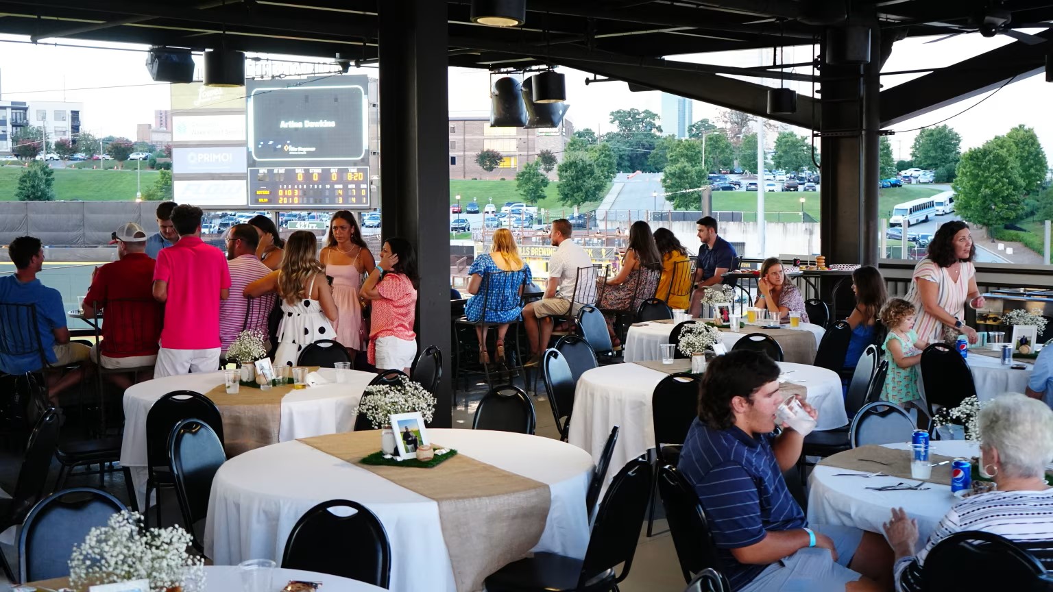 An engagement party takes place on a covered event space within Truist Stadium, home field of the Winston-Salem Dash Baseball team.