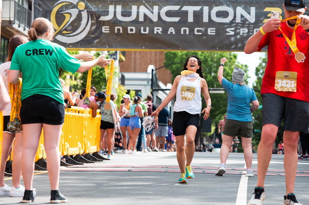 Runners reach the finish line and celebrate at the Craft Half Marathon in Winston-Salem.