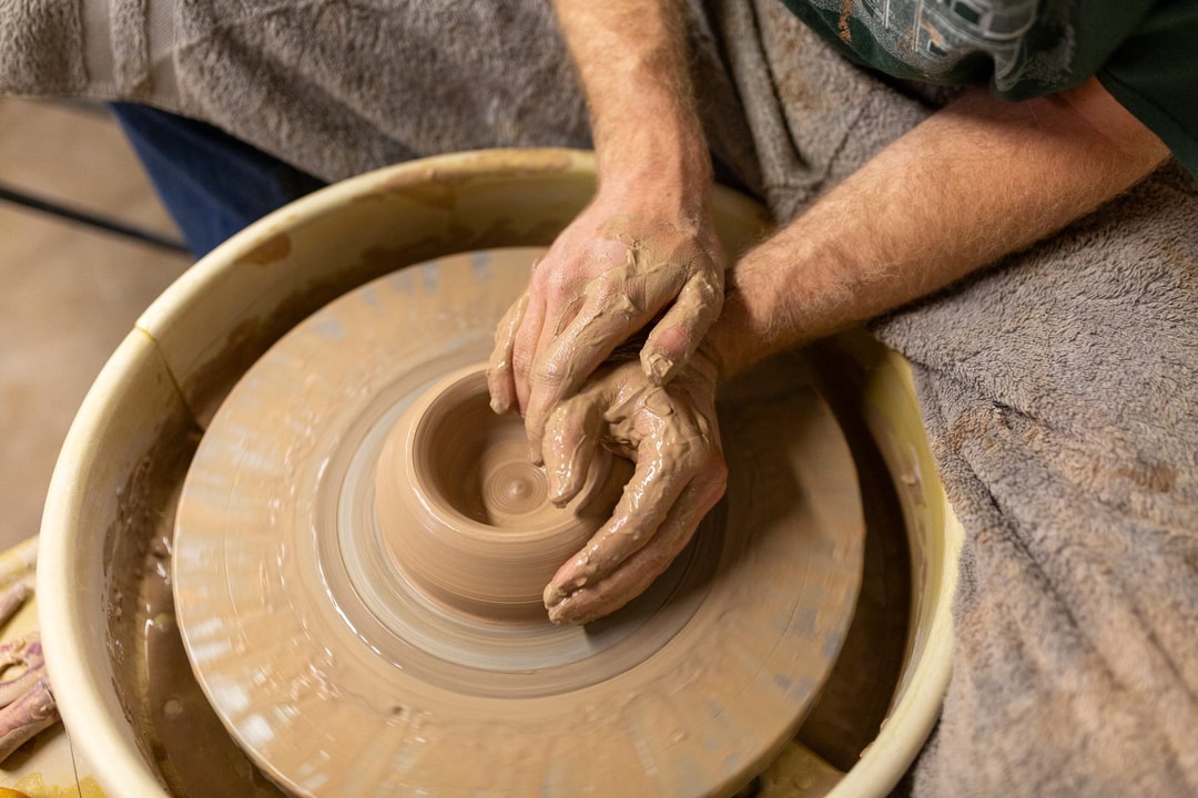 An artisan works a piece of clay on a pottery wheel at Sawtooth School for Visual Art in Winston-Salem.