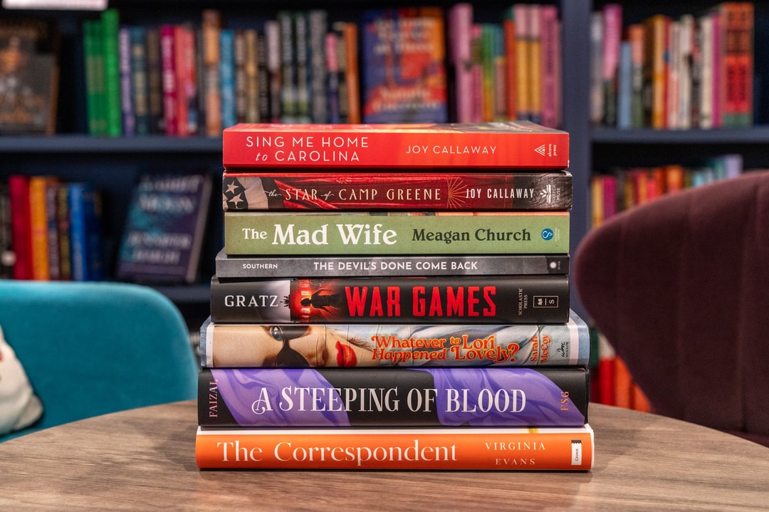 A stack of new-release fiction novels on a table inside of Bookmarks, a local independent bookstore in downtown Winston-Salem.