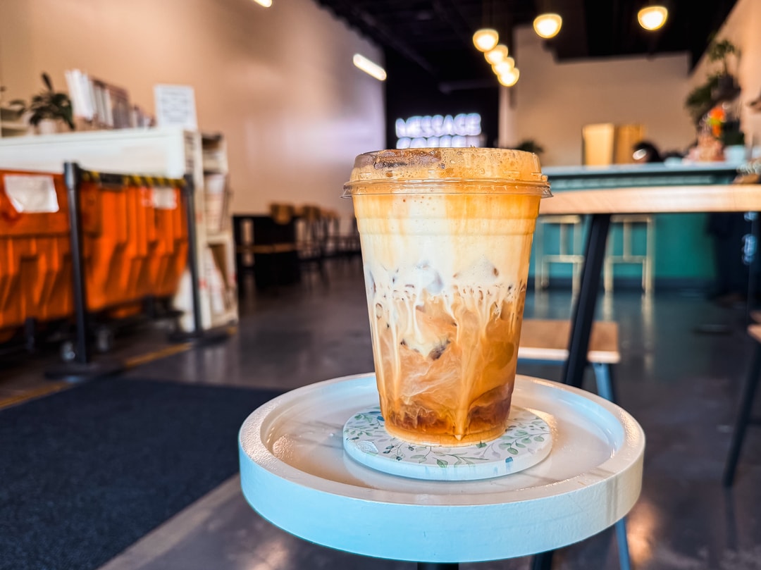 An iced latte sits on a small table inside Message Coffee, located in Kernersville.