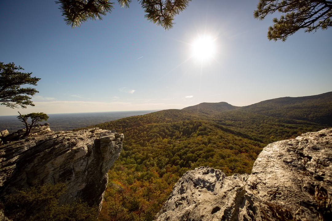 A wide angle overlook at Hanging Rock State Park, showing the valley and mountain range in the distance.