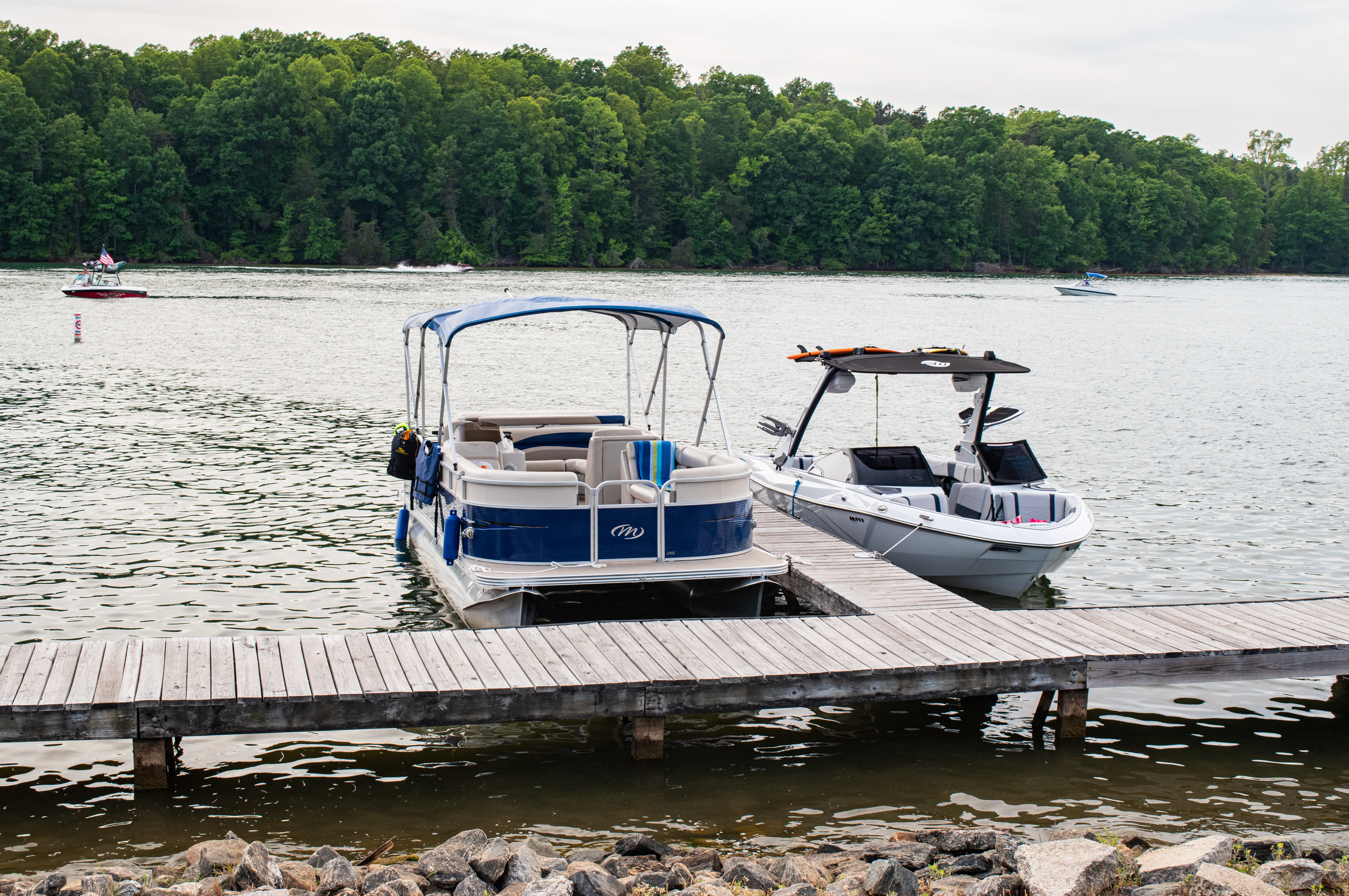 Two boats sit parked at a wooden dock at the Pine Hall boating access point on Belews Lake near Winston-Salem, North Carolina.