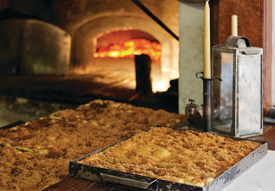 Moravian Sugar Cake baking in an oven at Winkler Bakery in Old Salem Museums & Gardens.