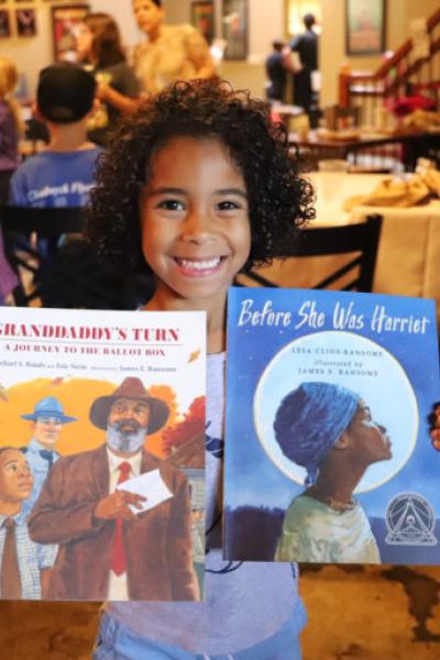 Child Holding Books Bookmarks