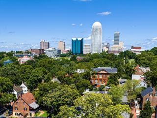 Skyline shot of downtown Winston-Salem with Main Street Old Salem in view.