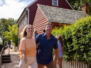 A male and female couple walks along Main Street in Old Salem.