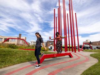 Two women walk through Artivity on the Green Park in downtown Winston-Salem, North Carolina