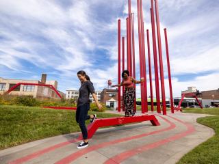 Two women walk through Artivity on the Green Park in downtown Winston-Salem, North Carolina