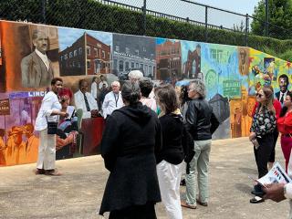 A guided African American Culture tour group at the Depot Street Mural in Downtown Winston-Salem.