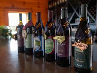 Wine bottles lined up in the tasting room at Dobbins Creek Vineyards.