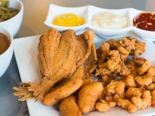 A plate of fried flounder, shrimp, and hushpuppies at Forsyth Seafood Market and Cafe.