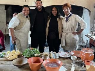 Jeremy Joyce, a Chicago-based food influencer, poses with a group of staff at Old Salem Museum and Gardens in Winston-Salem.