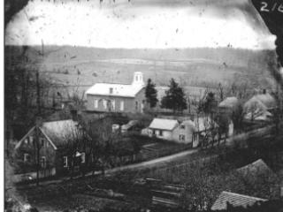A historical black and white photo of the original Happy Hill settlement in Winston-Salem, known then as "Liberia" or the Schumann Plantation.