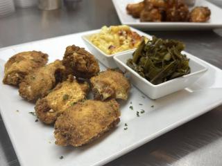 A plate of collard greens and chicken at Simply Sonya's Restaurant and Lounge.
