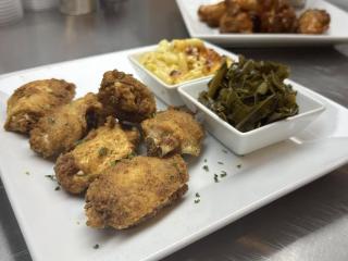 A plate of collard greens and chicken at Simply Sonya's Restaurant and Lounge.