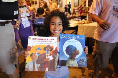 Child Holding Books Bookmarks