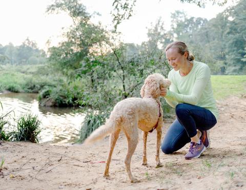 A dog and its owner hike at Reynolda Gardnes