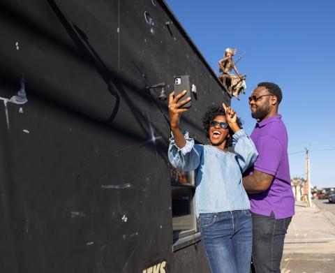A man and woman pose for a photo as they explore Winston-Salem's downtown arts district.
