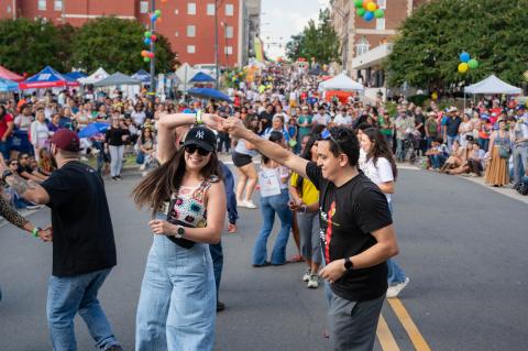 A group of couples dance in the street during the Hispanic League Fiesta street festival in Winston-Salem, North Carolina.