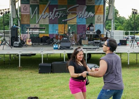 A couple dances in front of the stage at the Rock Out the Quarry event in Winston-Salem.