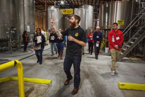 A group takes a tour of the Foothills Brewery and Tasting Room in Winston-Salem.
