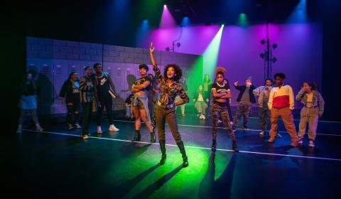 A full stage of actors during a performance at the Milton Rhodes Center for the Arts Spring Theatre
