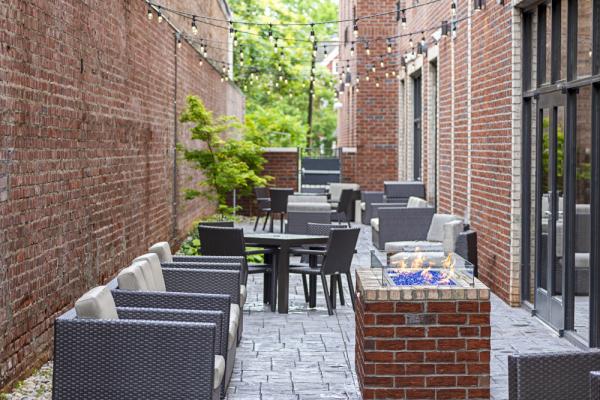 Unwind and connect at the outdoor patio space with plenty of lounging space and a fire pit. Photo 11