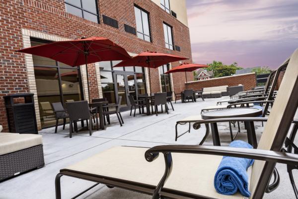 Enjoy some down time at our outdoor lounge patio, connected to our indoor heated saltwater pool. Photo 12