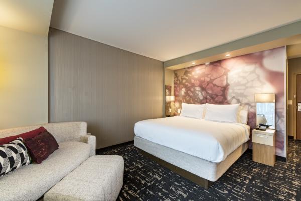 Our guest room showcases a fresh, progressive design that provides plenty of outlets and comfortable spaces for both relaxation and work. Photo 14