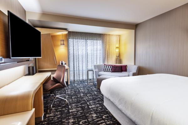 Our guest room showcases a fresh, progressive design that provides plenty of outlets and comfortable spaces for both relaxation and work. Photo 15