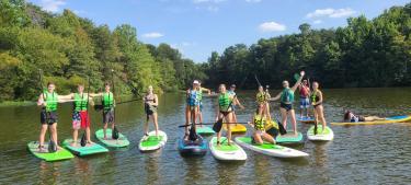 a group of people on stand up paddleboards at Salem Lake