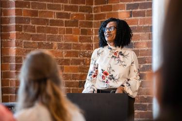 Brandy Evans- Visit Winston-Salem Chief Marketing Officer- addresses a group of hotel and community partners at a local PR forum.
