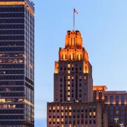 The Kimpton Cardinal Hotel RJR building lit up at night. Photo