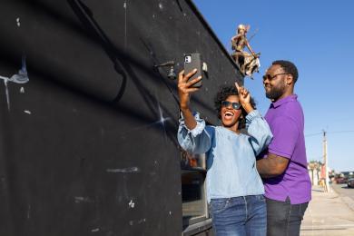 A man and woman pose for a photo as they explore Winston-Salem's downtown arts district.
